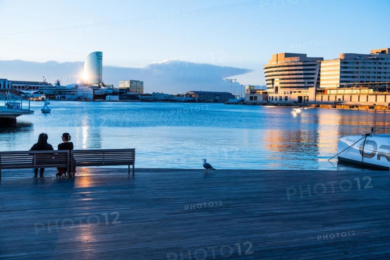 Two people sitting at the old harbour in Barcelona, Spain, Europe