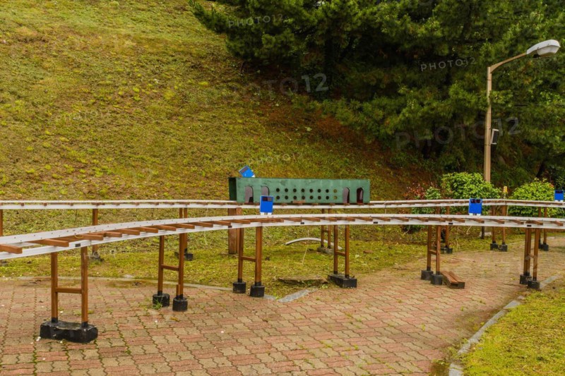 Miniature outdoor train station surrounded by trees on a cloudy day, in South Korea