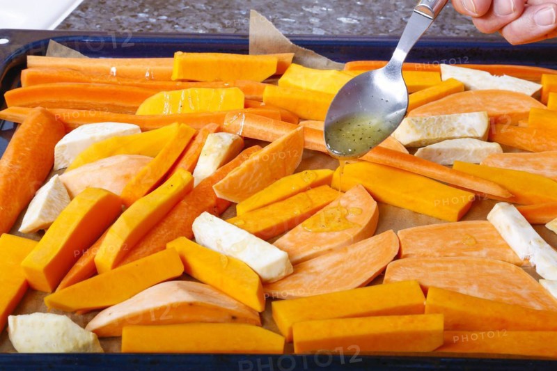 South German cuisine, butternut squash, butternut squash, pumpkin drizzled with olive oil, vegetables cut on baking tray, preparation of oven vegetables, pumpkin, fruit vegetables, fruit, carrots, celery, healthy cooking, vegetarian, vegan, autumn cuisine, pumpkin dishes, food, studio, man's hand, tablespoon, Germany, Europe