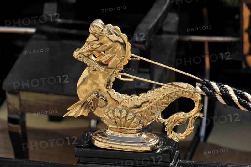 Close-up of a shiny golden seahorse figure on a Venetian gondola, Venice, Veneto, Italy, Europe