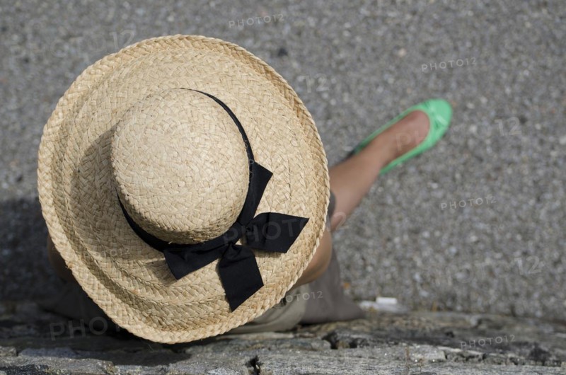 Woman with Straw Hat and Green Shoes and Leaning on the Wall
