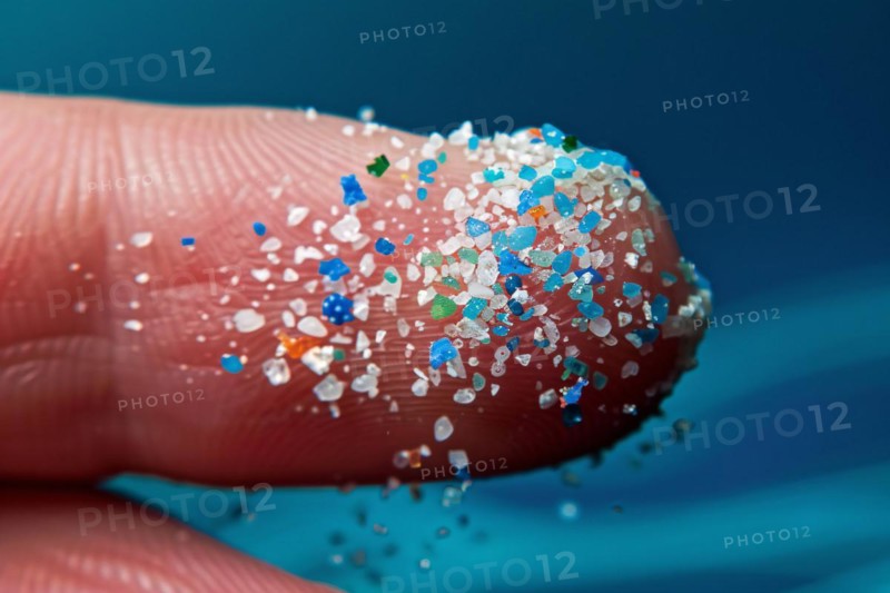 Small micro plastic particles on fingertip. KI generiert, generiert, AI generated