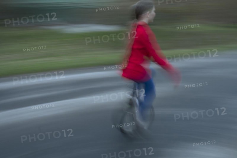 Girl, 10 years old, riding a unicycle, motion blur, Mecklenburg-Vorpommern, Germany, Europe