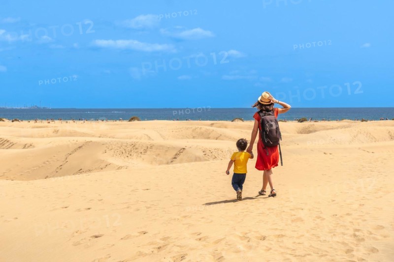 Mother and child on summer vacation in the dunes of Maspalomas, Gran Canaria, Canary Islands