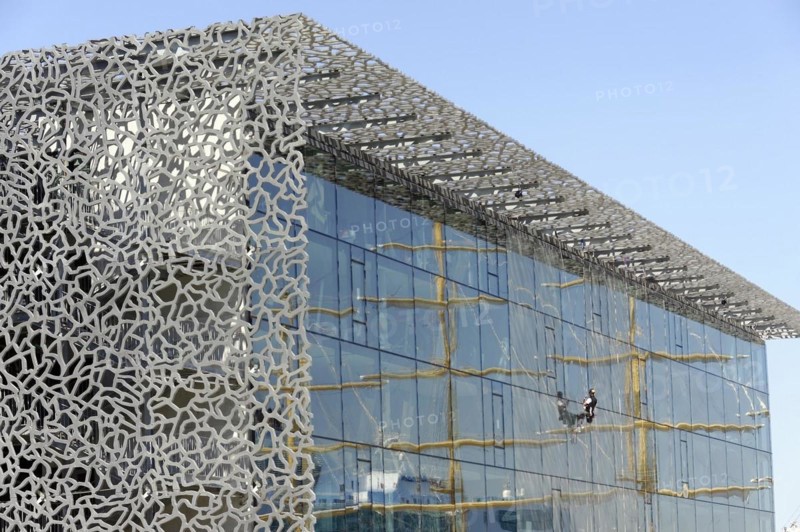 Marseille harbour, window cleaner working on the extraordinary facade of a modern building, Marseille, Departement Bouches-du-Rhone, Provence-Alpes-Cote d'Azur region, France, Europe