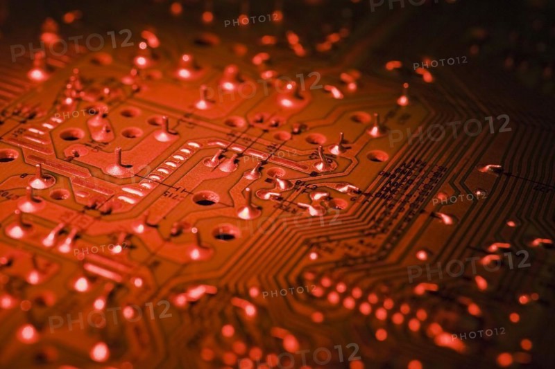 Close-up of red lighted electronic computer circuit board with silver solder points and lines, Studio Composition, Quebec, Canada, North America