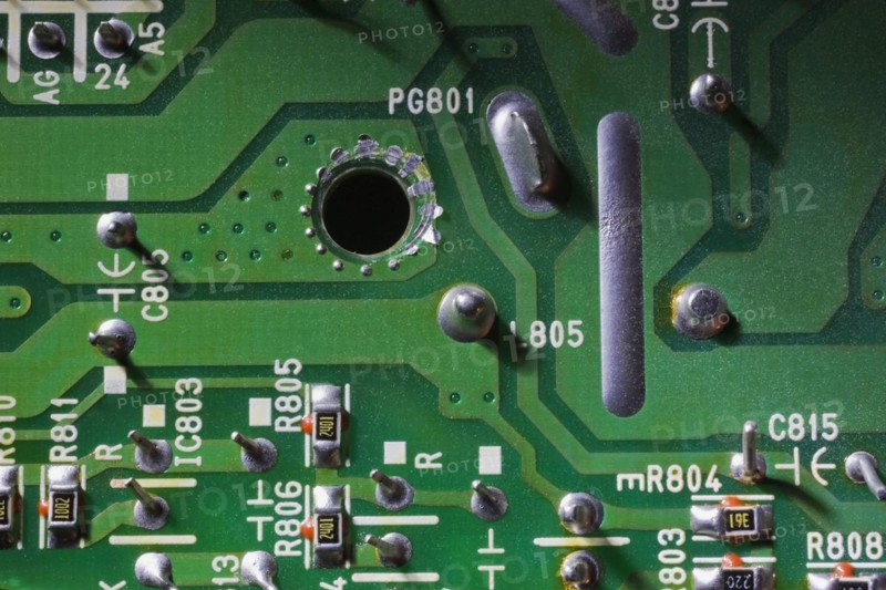 Close-up of green electronic computer circuit board with printed white numbers and letters and silver solder points, Studio Composition, Quebec, Canada, North America