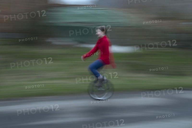 Girl, 10 years old, riding a unicycle, motion blur, Mecklenburg-Vorpommern, Germany, Europe