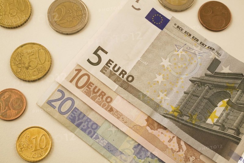 Close-up of five, ten, twenty Euro bank notes and assorted 2, 5, 10, 50 cent coins on white background, Studio Composition, Quebec, Canada, North America