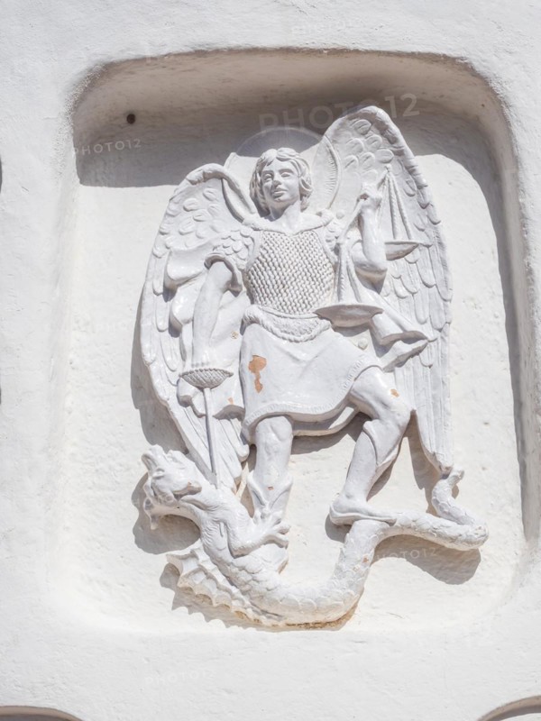 Stone sculpture, St George as dragon slayer, relief on the facade of the Stella Maris church, Porto Cervo, Costa Smeralda, Sardinia, Italy, Europe