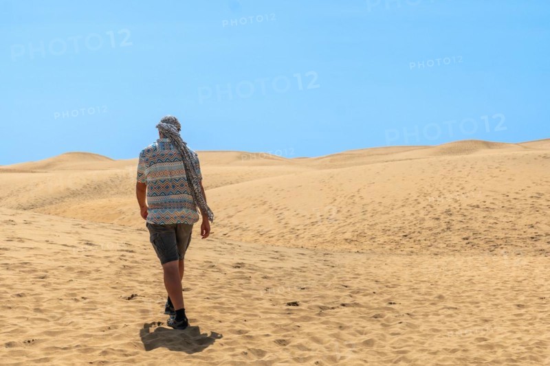 Portrait of male tourist in summer in the dunes of Maspalomas, Gran Canaria, Canary Islands