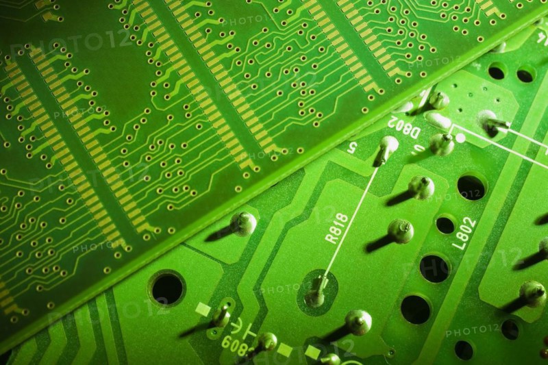 Close-up of fluorescent green lighted electronic computer circuit boards with silver solder points and lines, Studio Composition, Quebec, Canada, North America