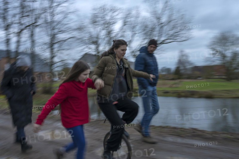 Family walk, a young woman with a unicycle, motion blur, Mecklenburg-.Vorpommern, Germany, Europe