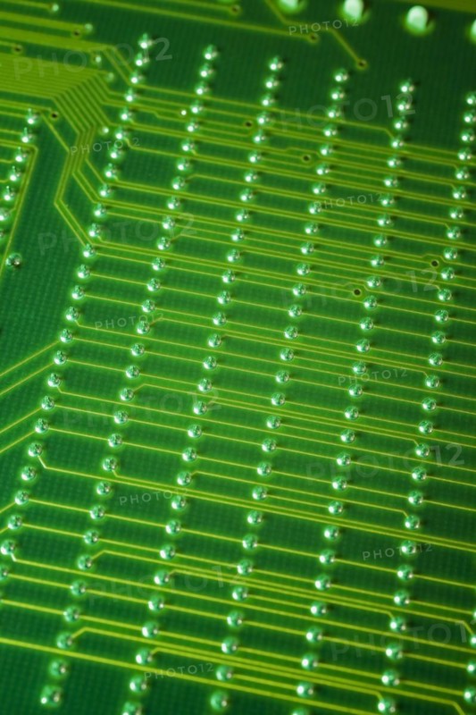 Close-up of fluorescent green lighted electronic computer circuit board with lines and silver solder points, Studio Composition, Quebec, Canada, North America