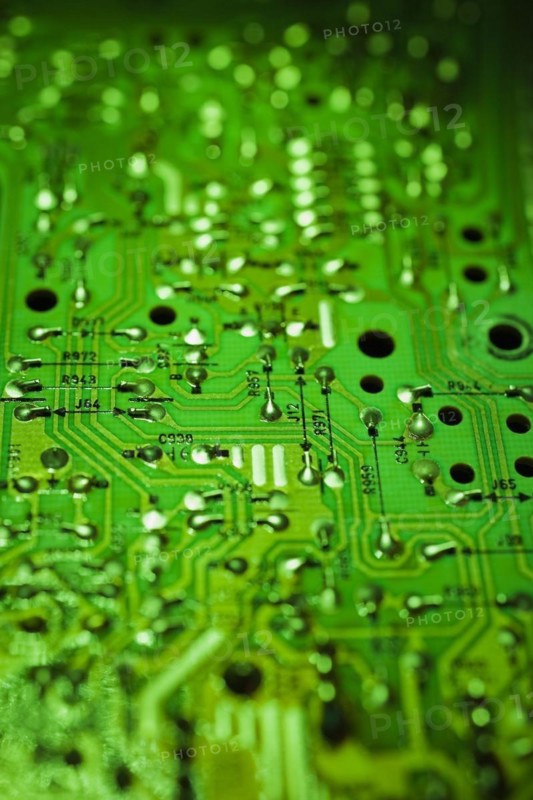Close-up of green lighted electronic computer circuit board with silver solder points and lines, Studio Composition, Quebec, Canada, North America