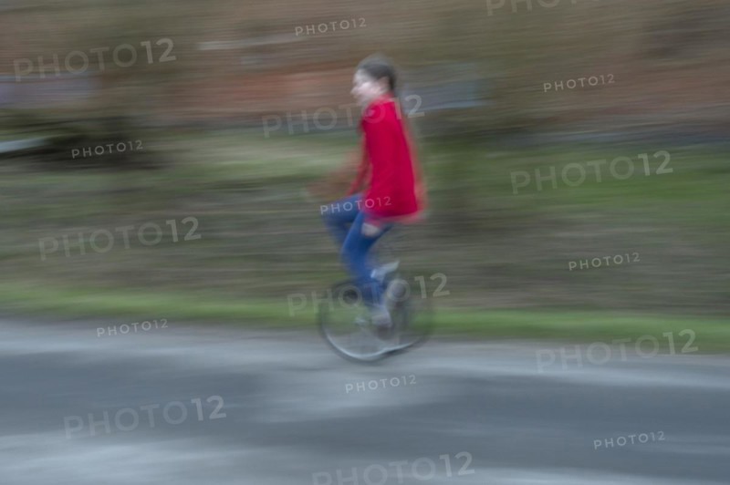 Girl, 10 years old, riding a unicycle, motion blur, Mecklenburg-Vorpommern, Germany, Europe