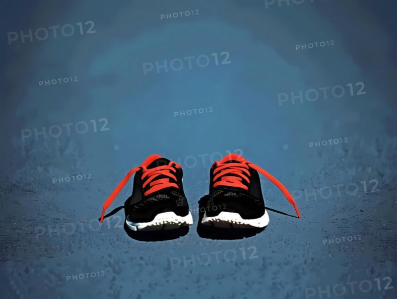 Pair of stylish sneakers with red accents on a reflective surface, illustration, AI generated