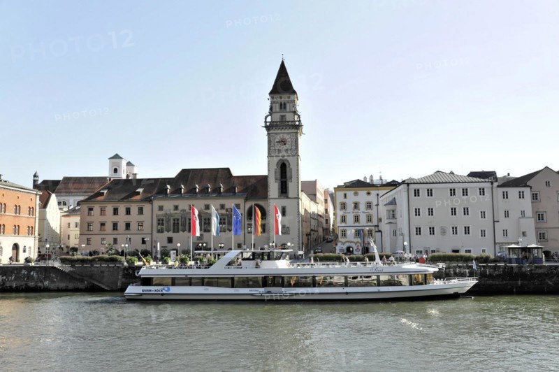 Ships on the river (Danube) in front of a town with a prominent church tower, Passau, Bavaria, Germany, Europe