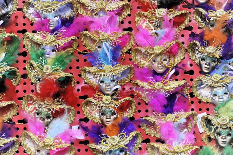 Colourful carnival masks with feather decorations present the lively celebration of the Venetian carnival, Venice, Veneto, Italy, Europe