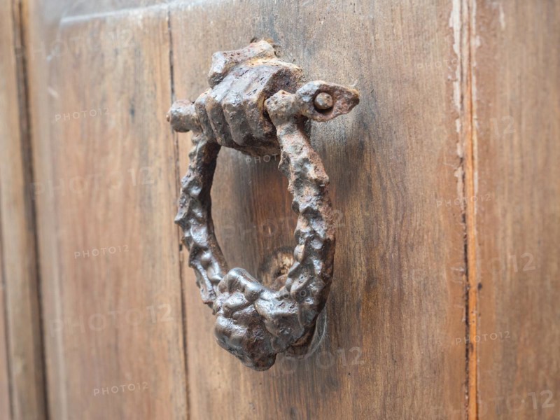 Hand holding door knocker, Alghero, Sardinia, Italy, Europe