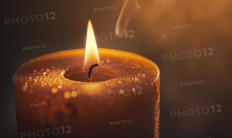 Close-up of a candle's gentle flicker illuminating a serene setting AI generated