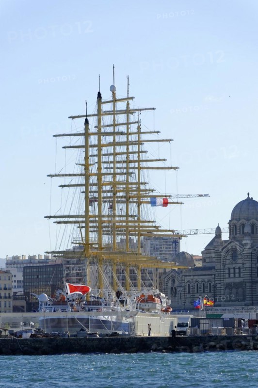 Marseille in the morning, Historic tall ship in the harbour in front of the city skyline under a blue sky, Marseille, Departement Bouches-du-Rhone, Region Provence-Alpes-Cote d'Azur, France, Europe