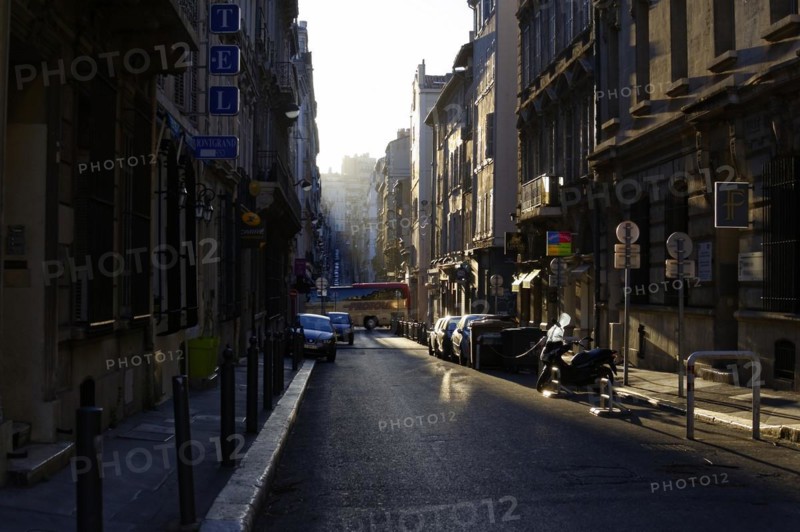 Marseille in the morning, city street with sunlit and shaded areas and parked cars, Marseille, Departement Bouches-du-Rhone, Region Provence-Alpes-Cote d'Azur, France, Europe