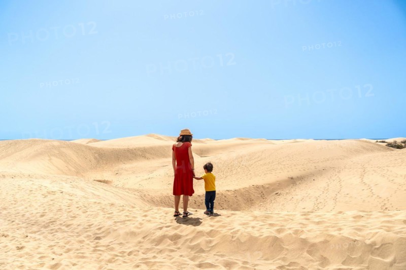 Mother and son on vacation very happy in the dunes of Maspalomas, Gran Canaria, Canary Islands
