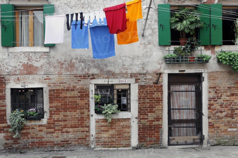 Colourful laundry hanging on a washing line in front of old Venetian house facades, Venice, Veneto, Italy, Europe