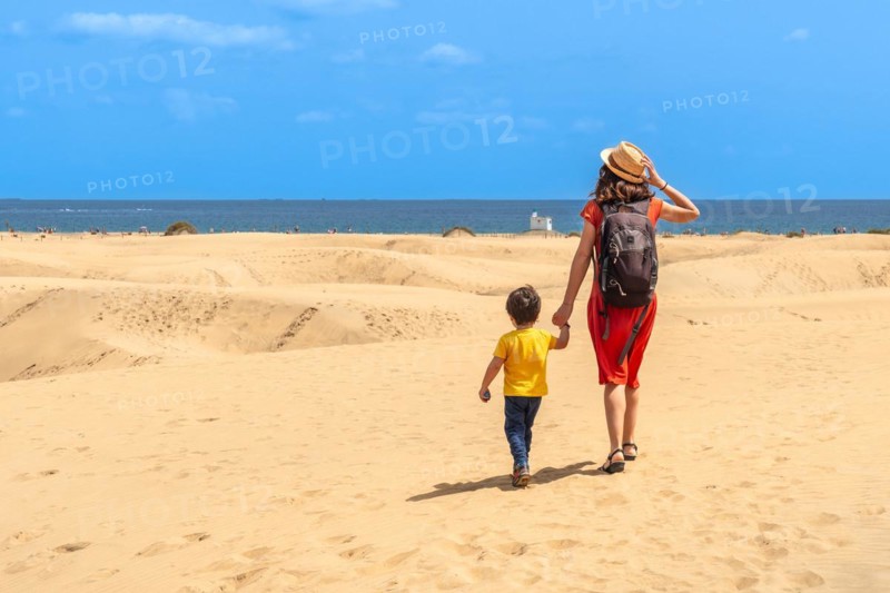 Mother and child on summer vacation in the dunes of Maspalomas, Gran Canaria, Canary Islands