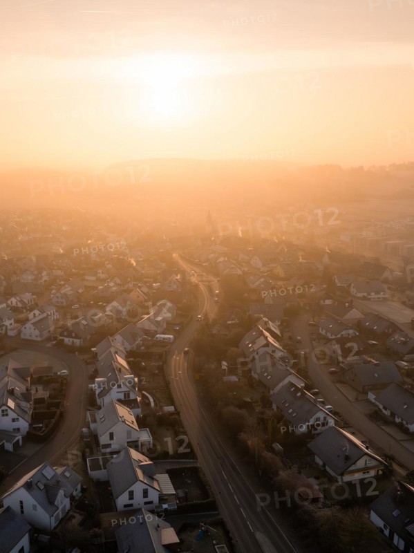 Sunrise casts a soft light on a town and its church towers in the distance, Gechingen, Black Forest, Germany, Europe
