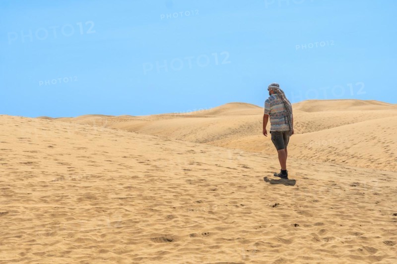 Portrait of male tourist in summer in the dunes of Maspalomas, Gran Canaria, Canary Islands