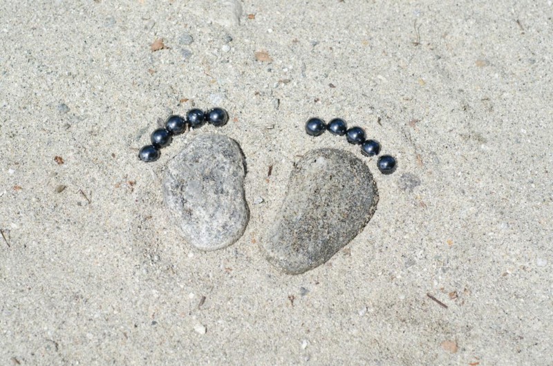 Footprints Made of Stones in the Sand