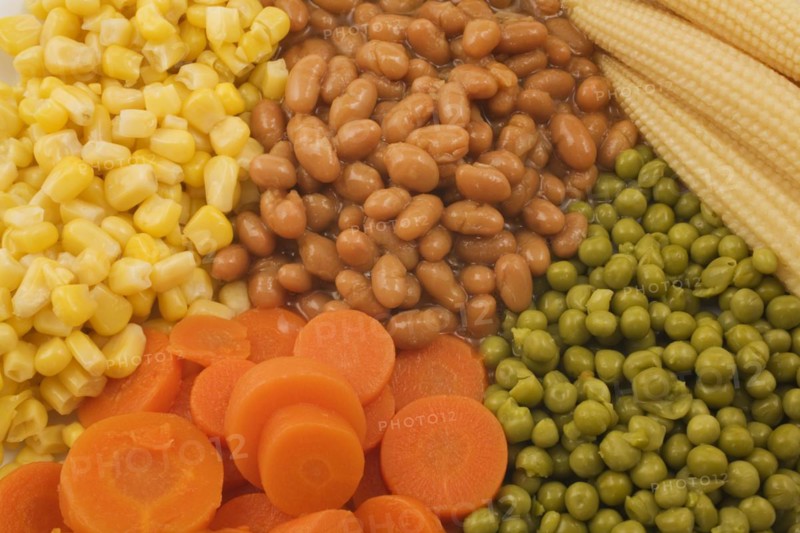 Close-up of mixed cooked vegetables that include brown baked beans, green peas, orange carrots and yellow corn kernels, Studio Composition, Quebec, Canada, North America