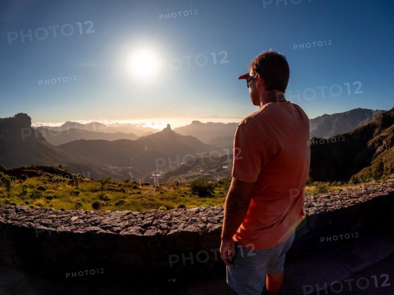 A young boy at sunset near Roque Nublo in Gran Canaria, Canary Islands