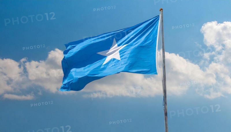 The flag of Somalia, fluttering in the wind, isolated, against the blue sky