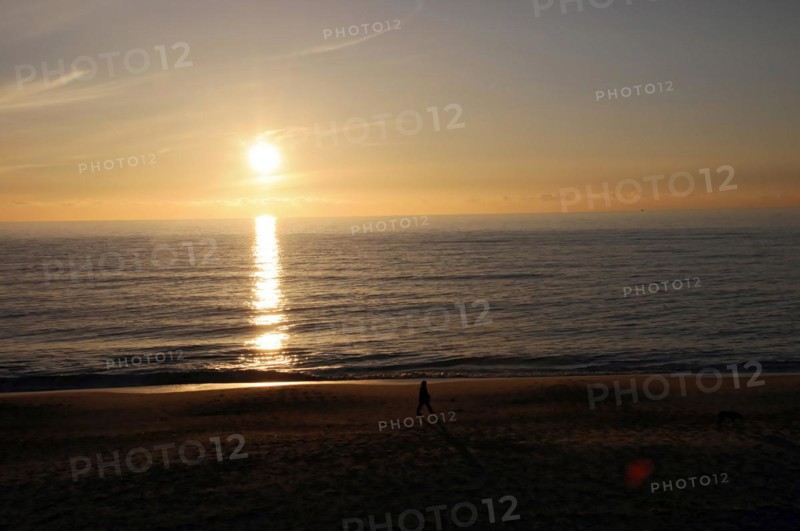 Beach 5 km south of Westerland, Sylt, North Frisian Island, Schleswig Holstein, Beach at sunset with the silhouette of a person and the sun reflected in the water, Sylt, North Frisian Island, Schleswig Holstein, Germany, Europe