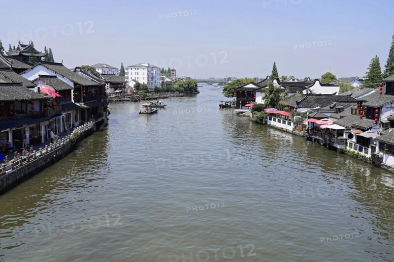 Excursion to Zhujiajiao water village, Shanghai, China, Asia, wooden boat on canal with view of historic architecture, view of a river with boats and traditional buildings on both banks, Asia