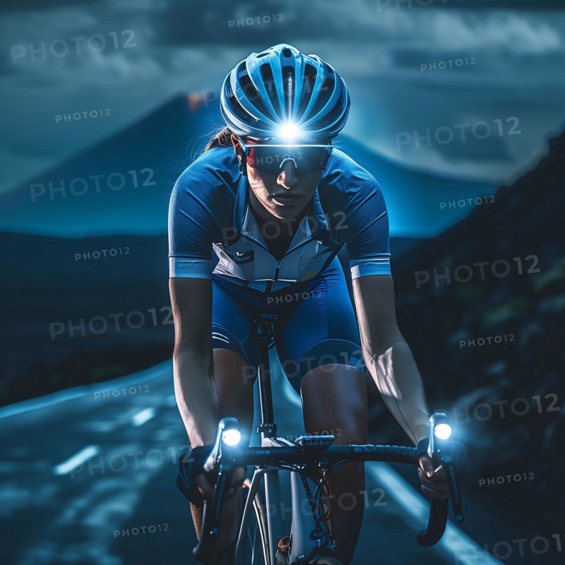 Cyclist riding at night on a winding mountain road, surrounded by the gentle contours of the mountains, AI generated