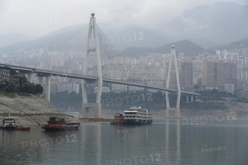 Chongqing, Chongqing Province, Modern bridge over a river with light fog, cityscape behind, Chongqing, Chongqing Province, China, Asia
