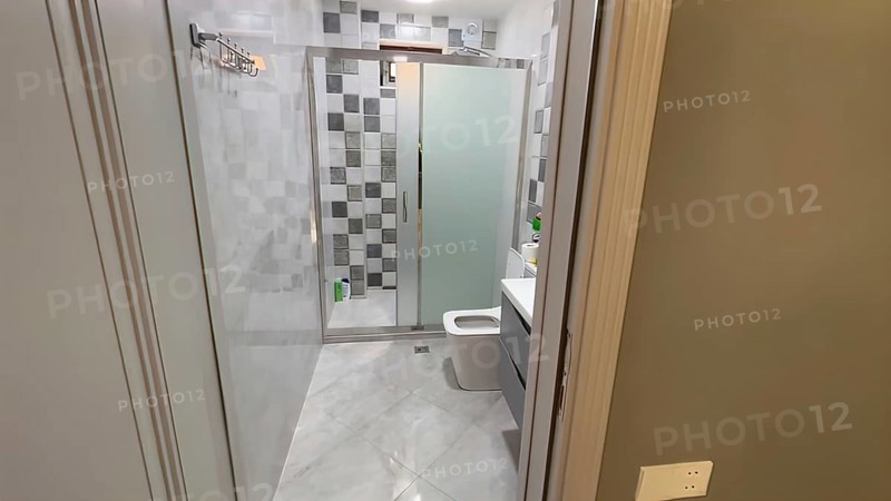 Interior of a modern bathroom with shower and toilet. Nobody inside