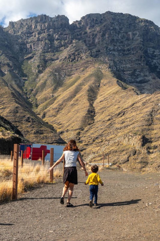 A mother and her son walking and having fun in the mountains of the Agaete coast, Roque Guayedra, Gran Canaria