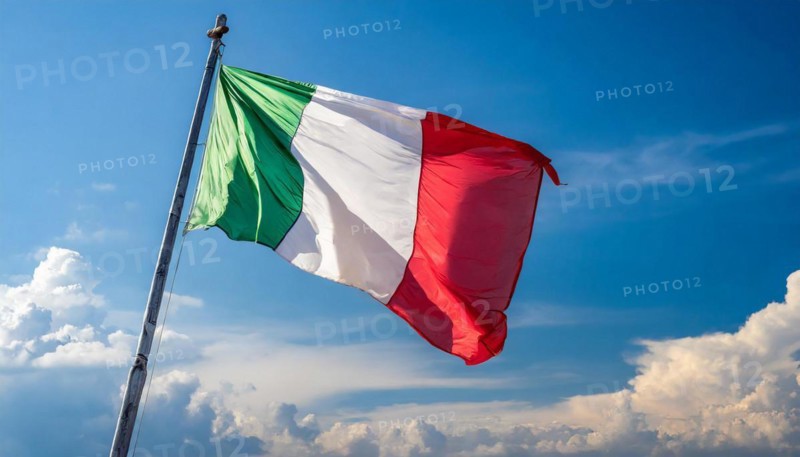 The flag of Italy flutters in the wind, isolated against a blue sky