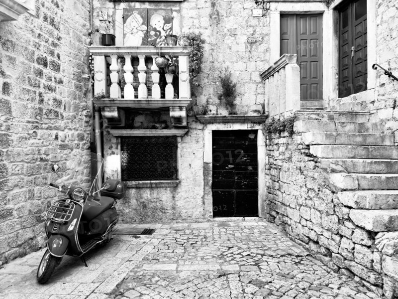 Black and white picture of a Vespa in an old-fashioned alley, Trogir, Dalmatia, Croatia, Europe