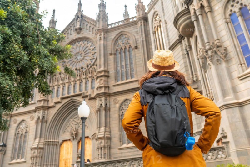 A tourist with a hat visiting the Church of San Juan Bautista, Arucas Cathedral, Gran Canaria, Spain, Europe