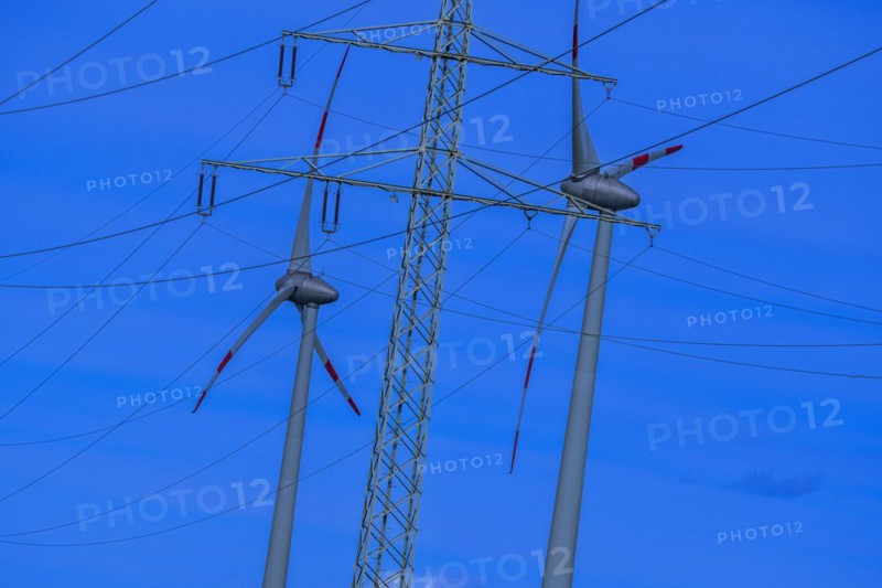 Wind energy in an inclined position, theme photo, electricity pylon with high-voltage lines and wind turbines at the Avacon substation in Helmstedt, Helmstedt, Lower Saxony, Germany, Europe