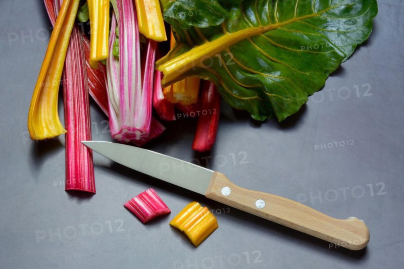 Red and yellow chard, kitchen knife and chopped stems, Beta vulgaris