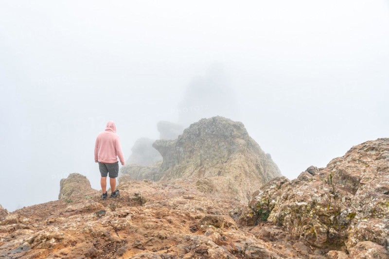 A tourist inside the fog on the very cloudy Pico de las Nieves in Gran Canaria, Canary Islands. Spain