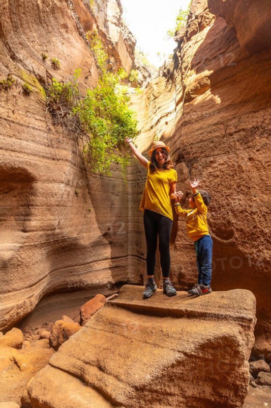 Family on vacation enjoying in the limestone canyon Barranco de las Vacas in Gran Canaria, Canary Islands