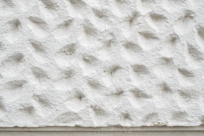 Roughly patterned plastered wall in detail, background and structure